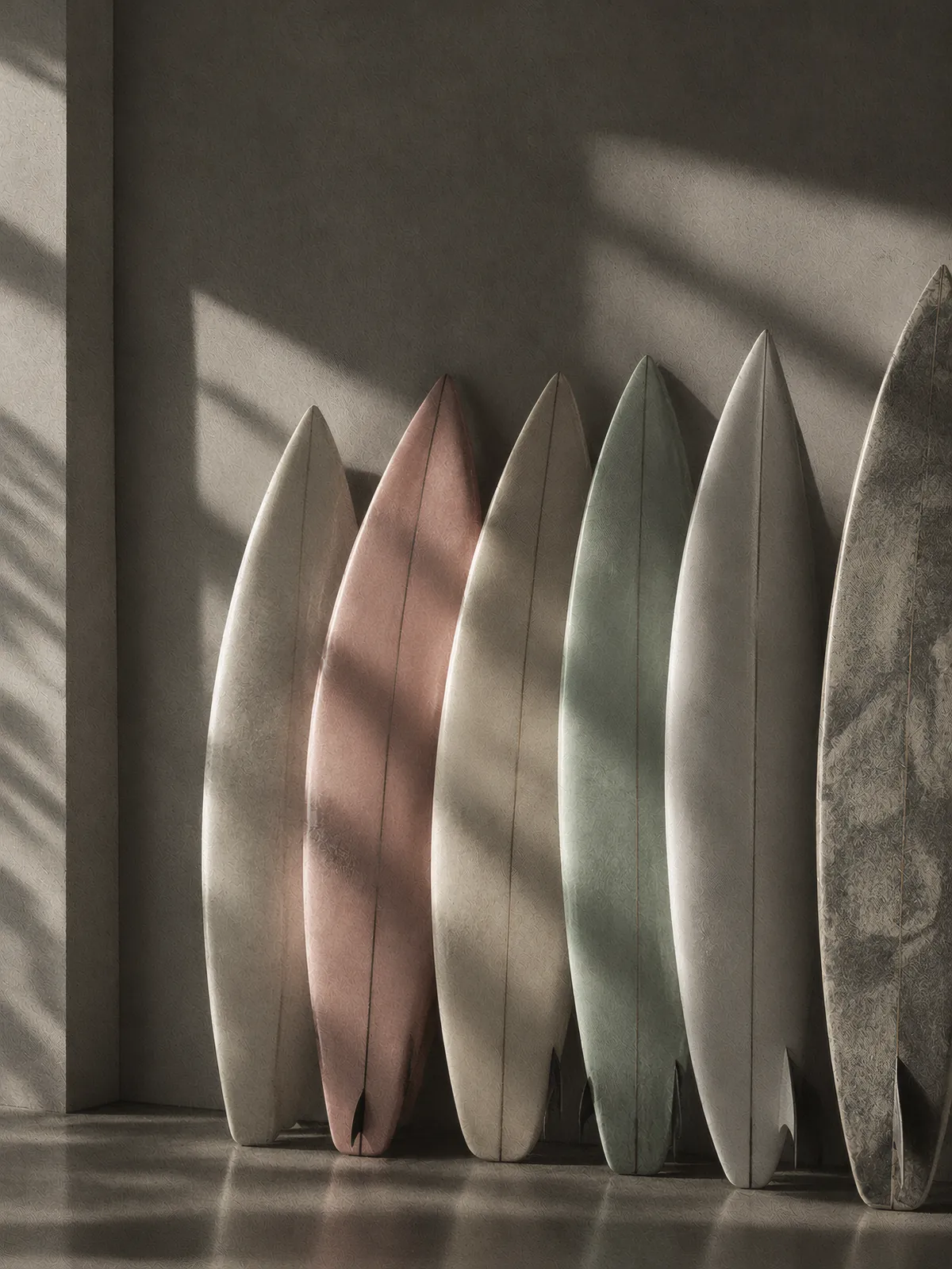 Surfboards leaning against a sunlit wall in a surf town